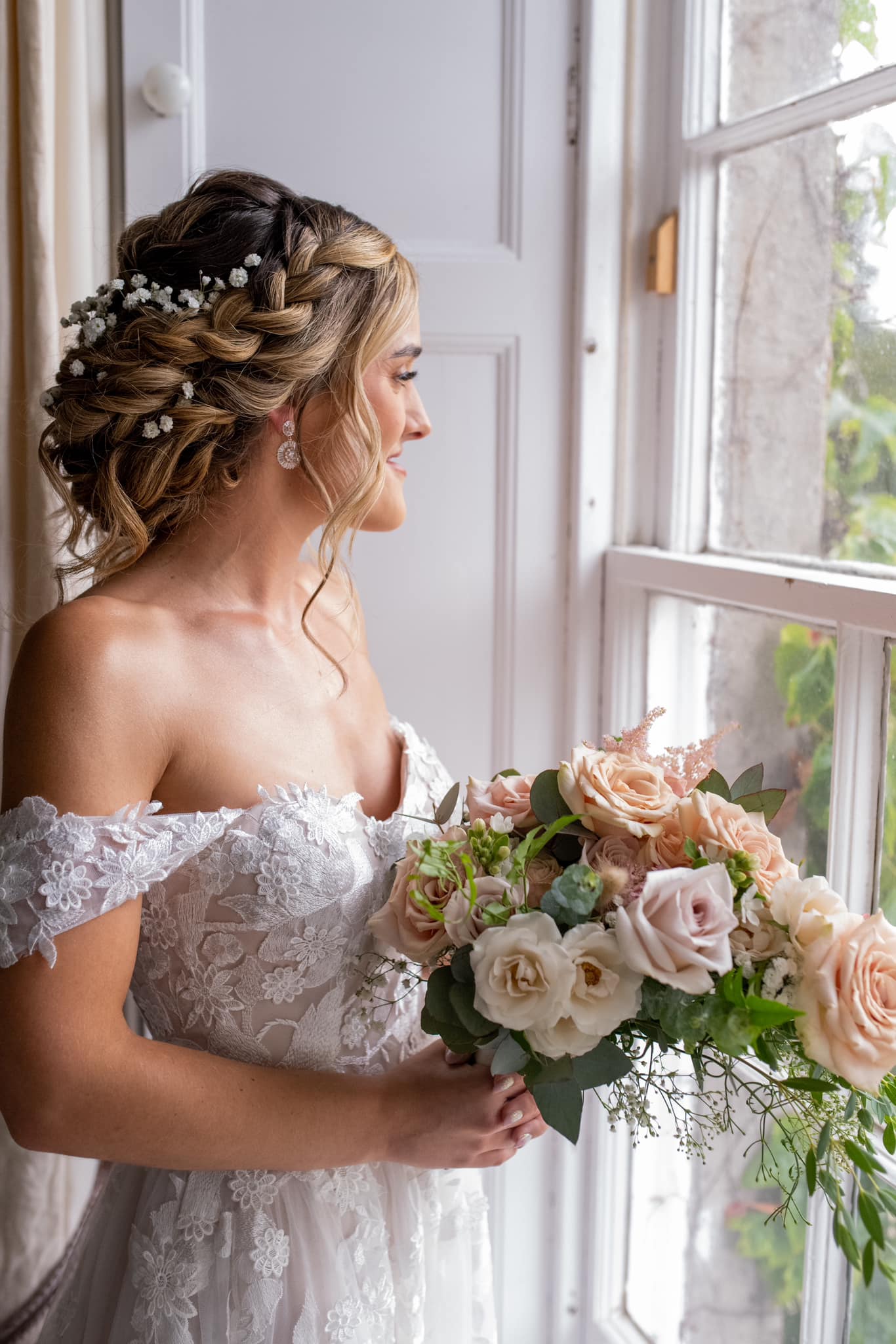 Bride by a window showing a detailed side and back updo