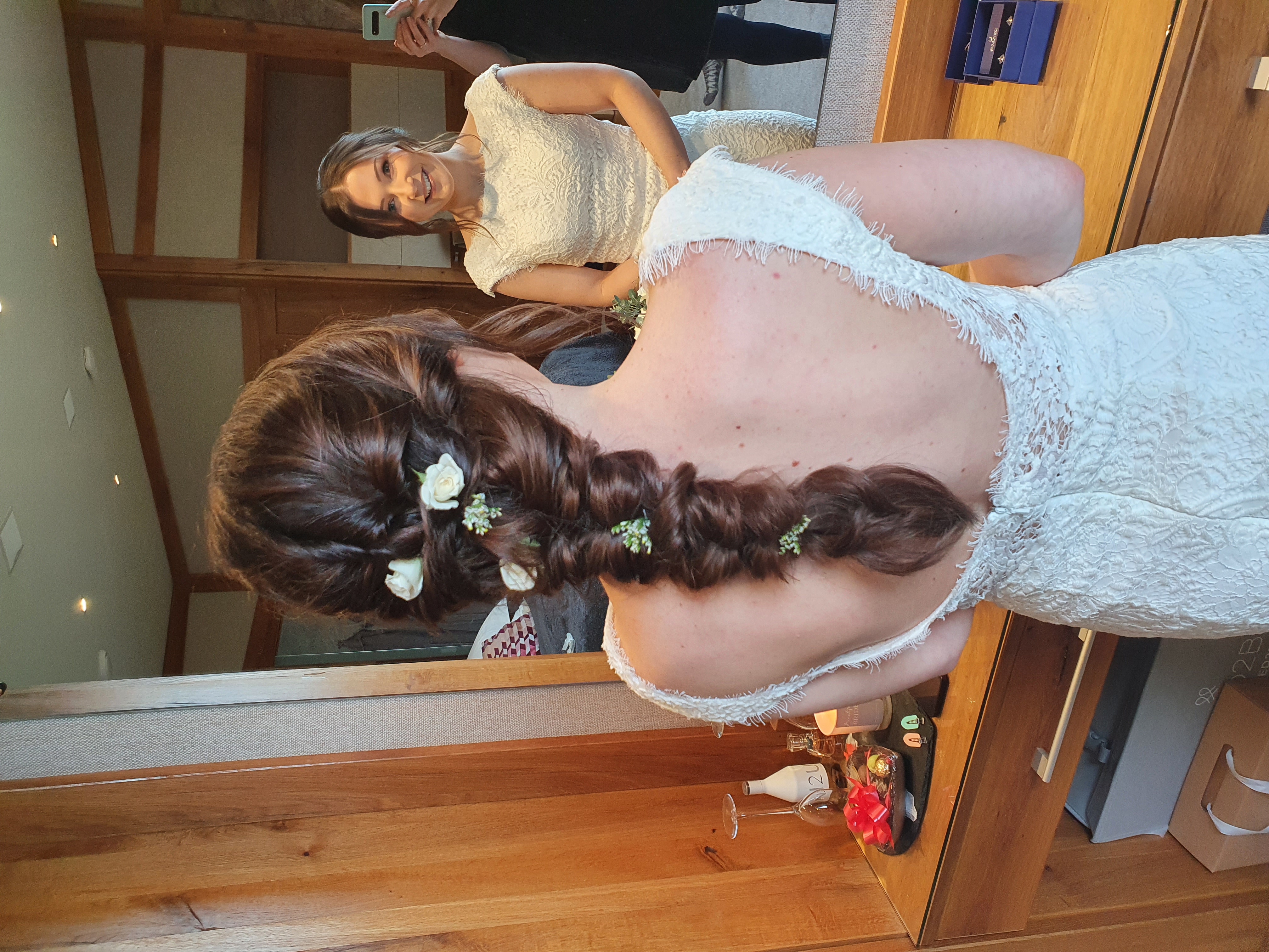 Back view of a dark braided bridal style with small flowers