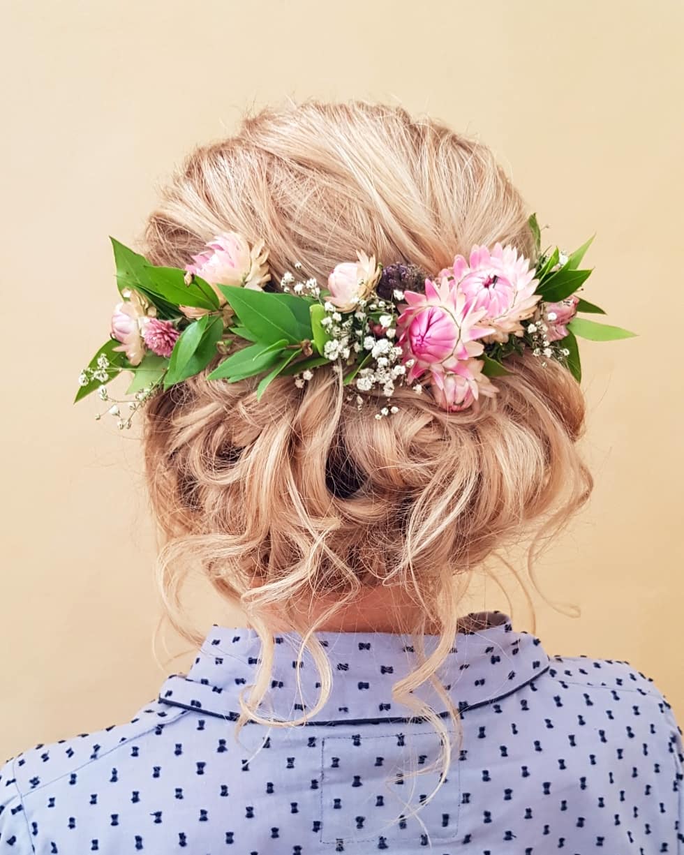 Blonde braided updo with a floral crown