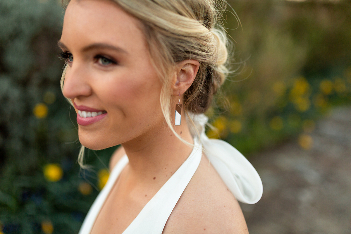 Blonde bride with elegant styled hair and makeup outdoors